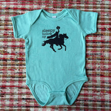 Light blue baby onesie with black graphic of Headless Horseman and text that reads "sleepy hollow ny"